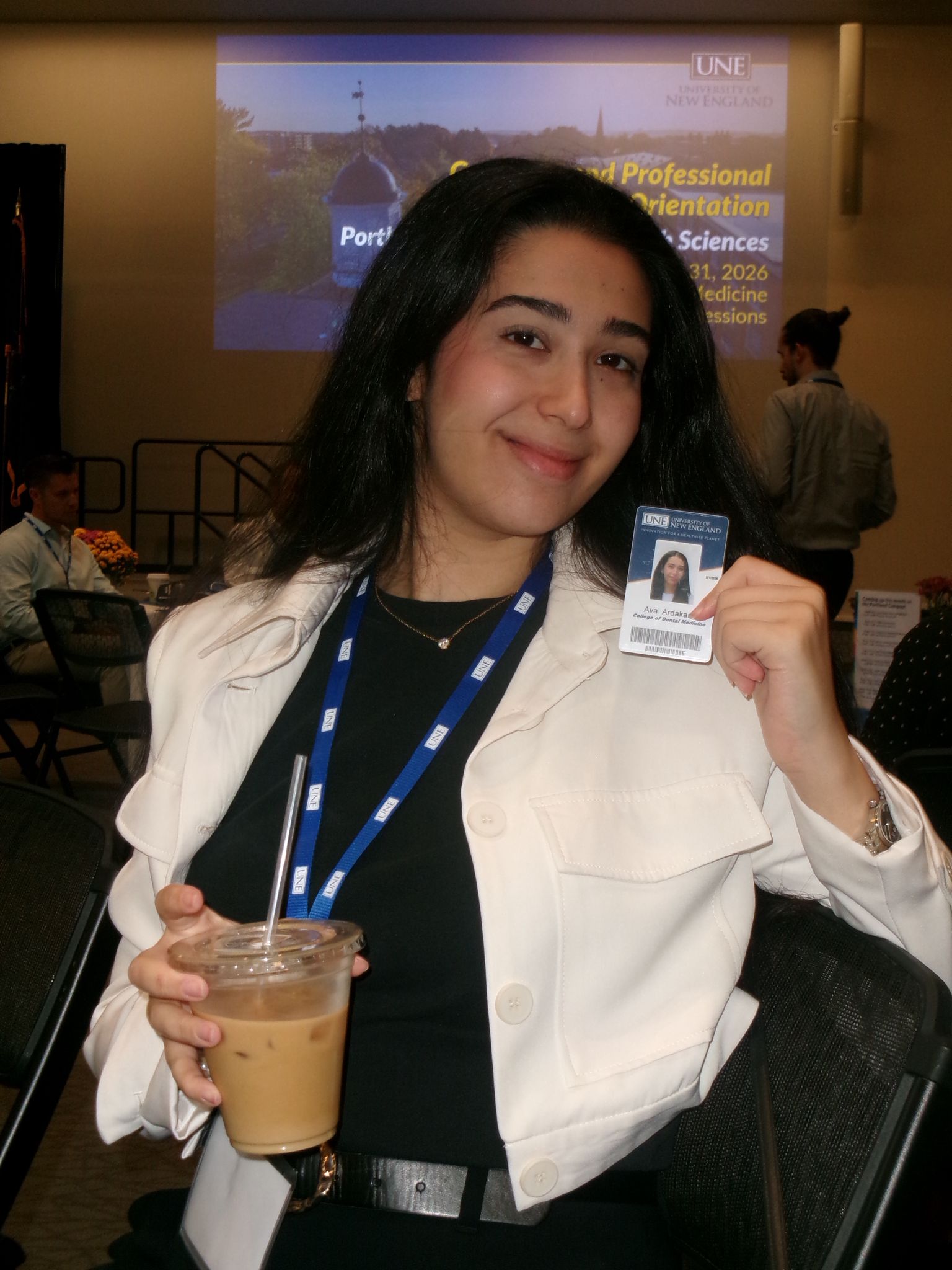 Ava holding student card at pre-dental seminar